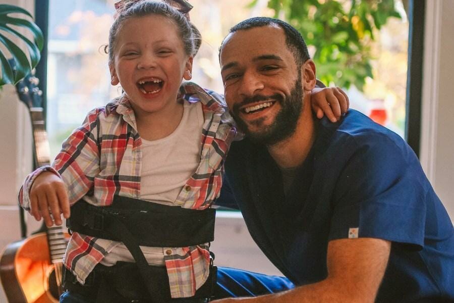 A pediatric nurse and his young patient.