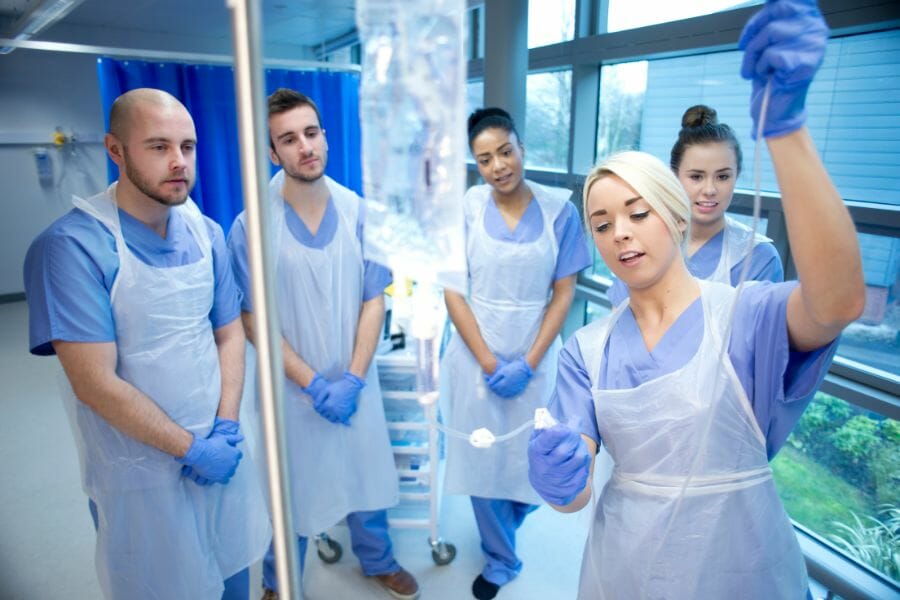 nurses learning how to prepare an IV
