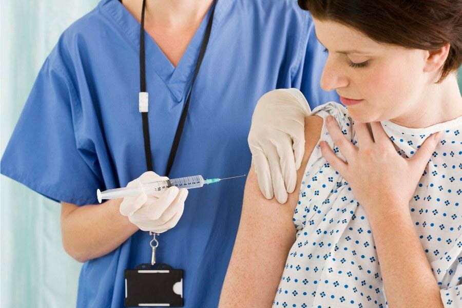 A nurse preparing a medication injection.