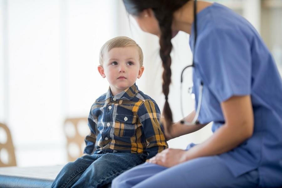 An in home nurse and young patient.