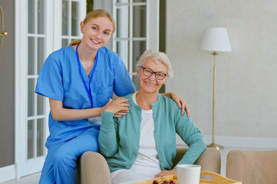A local concierge nurse smiling with her client.