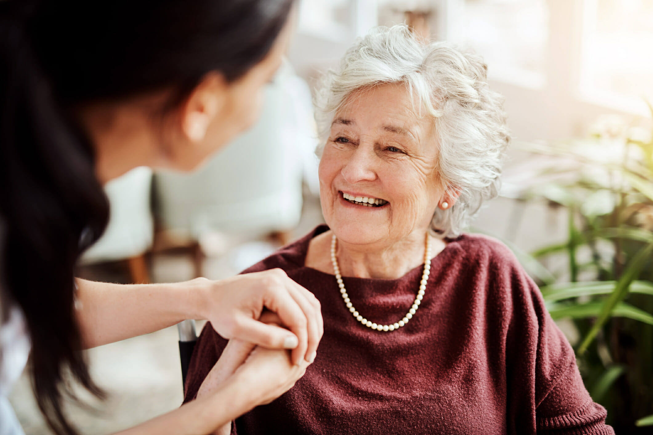 senior woman smiling with nurse at home senior woman smiling with nurse at home