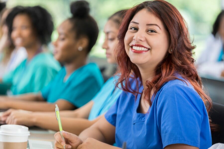 A smiling nurse continuing their education.