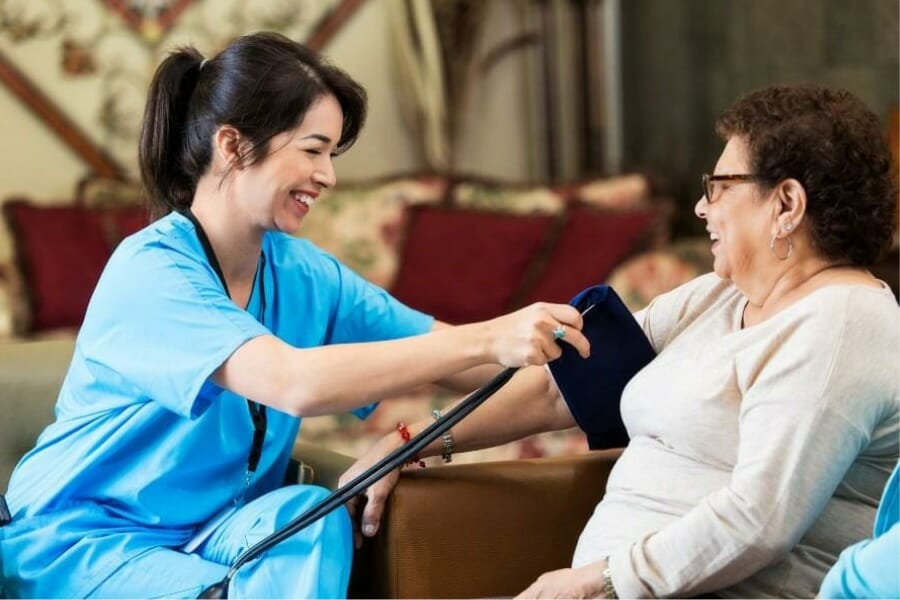 A local private duty nurse checking a patient's blood pressure.