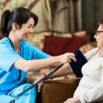 private nurse checking a client's blood pressure in their home in Sleepy Hollow, California.