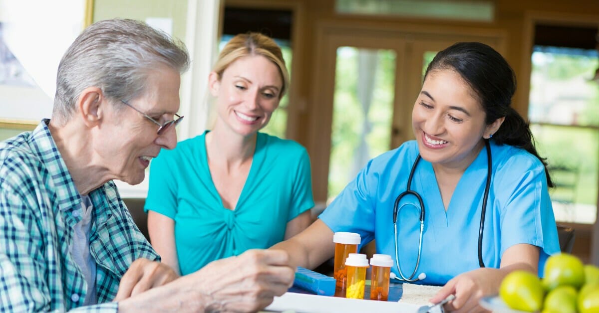 a private duty nurse and home health aid working with a patient.