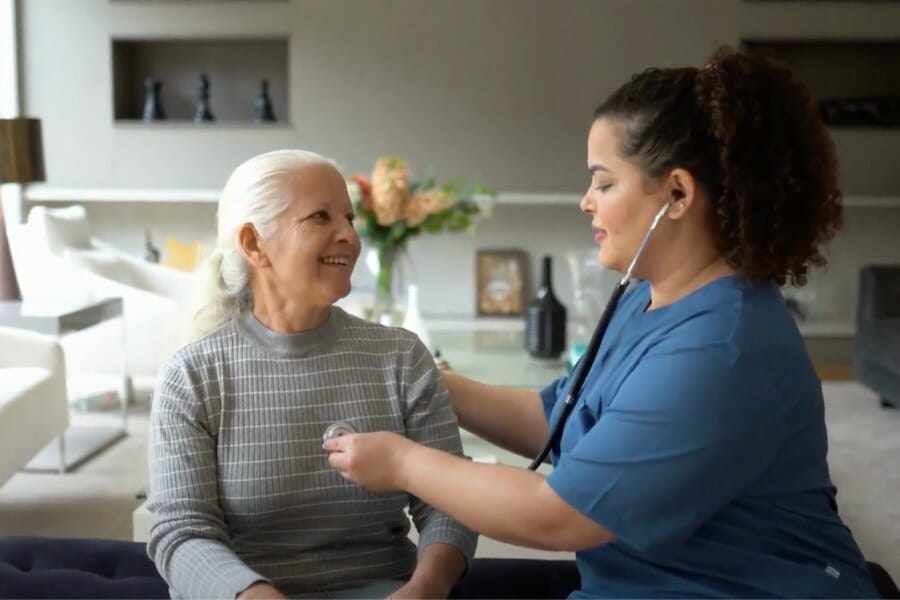 Private nurse checking a patient's heart beat