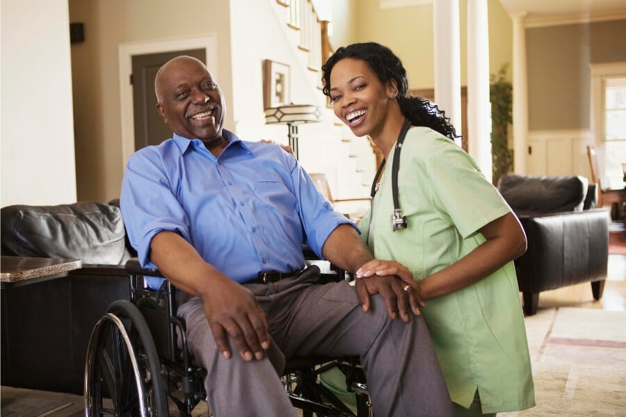 A patient in a wheel chair and an in home nurse