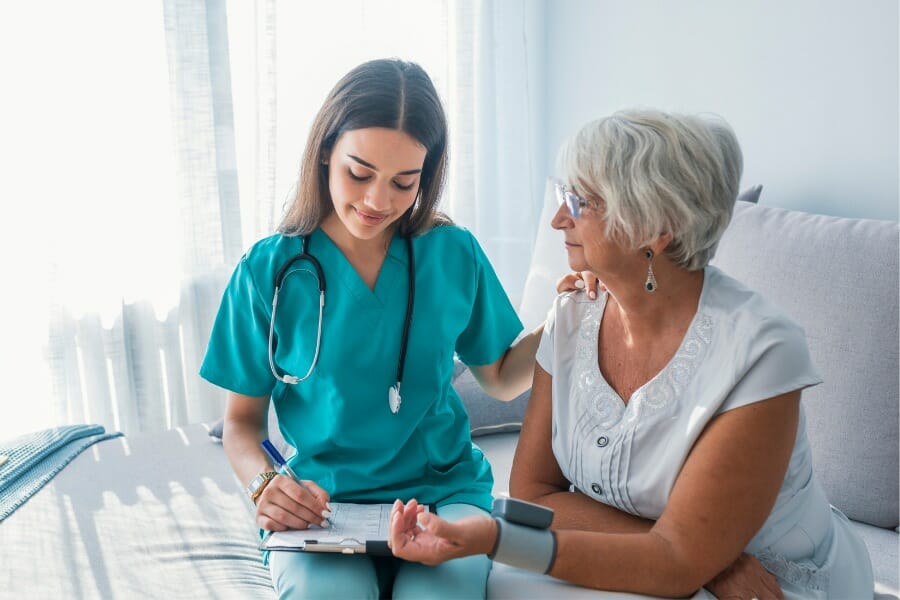 A private duty nurse doing an assessment with her client.