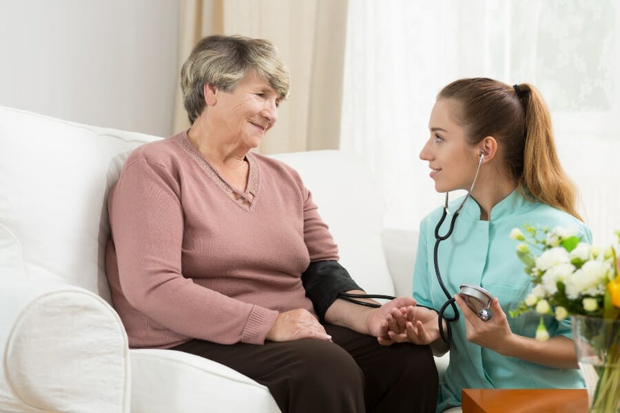 An elderly patient receiving in home teaching from her private nurse.