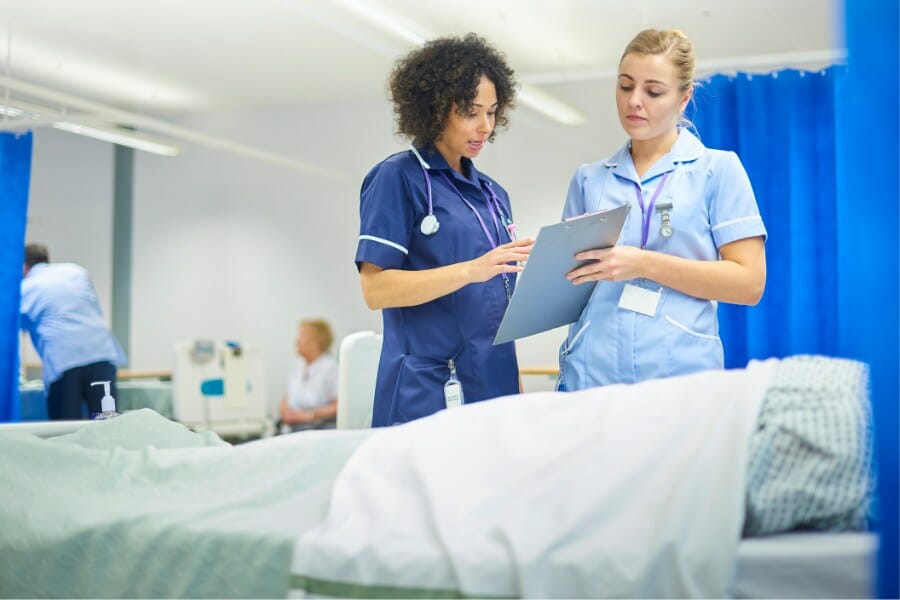 Nurses discussing a patient record at a skilled nursing facility