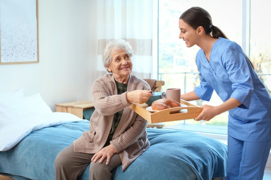 private nurse helping her senior patient