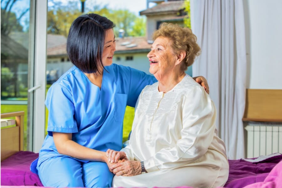 private duty nurse with her elderly patient aging at home