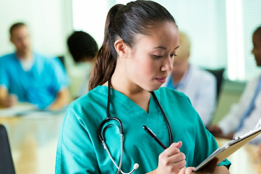 A nurse checking her charts.