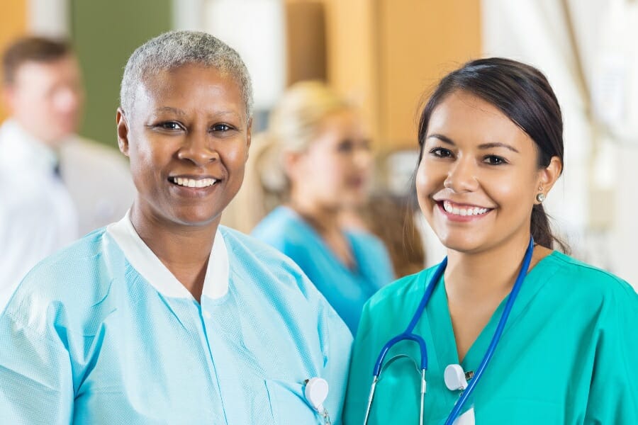 An RN and her LVN friend smiling