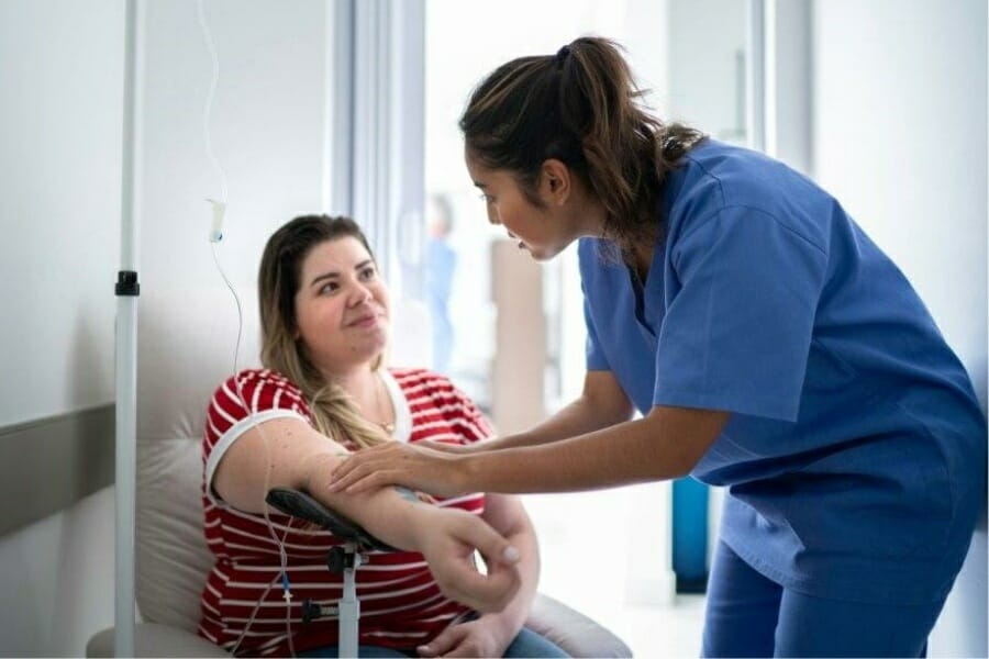 RN working closely with patient at a hospital