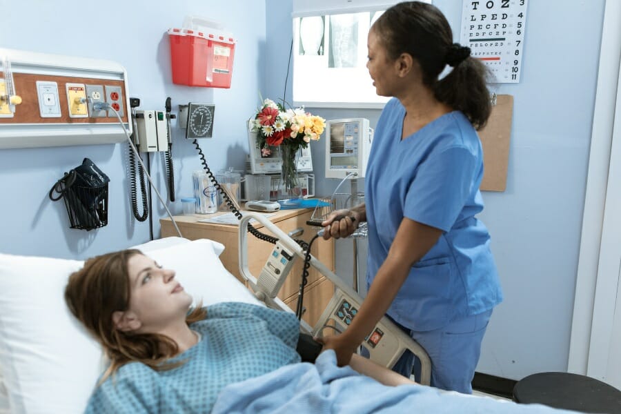 A nurse checking a patient's blood pressure.