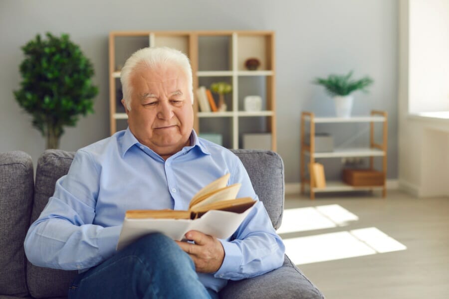 An elderly gentelman reading a book