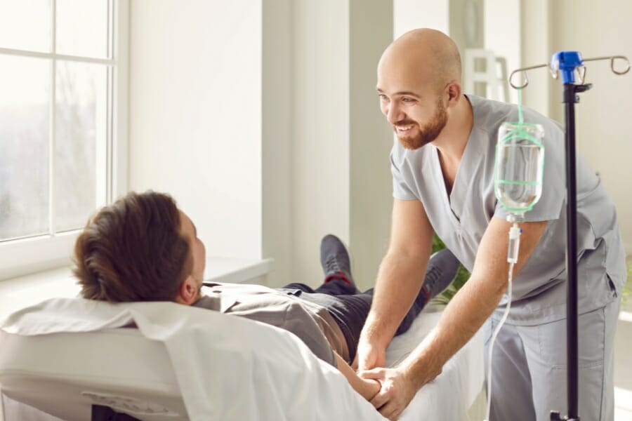 male nurse assisting his patient.