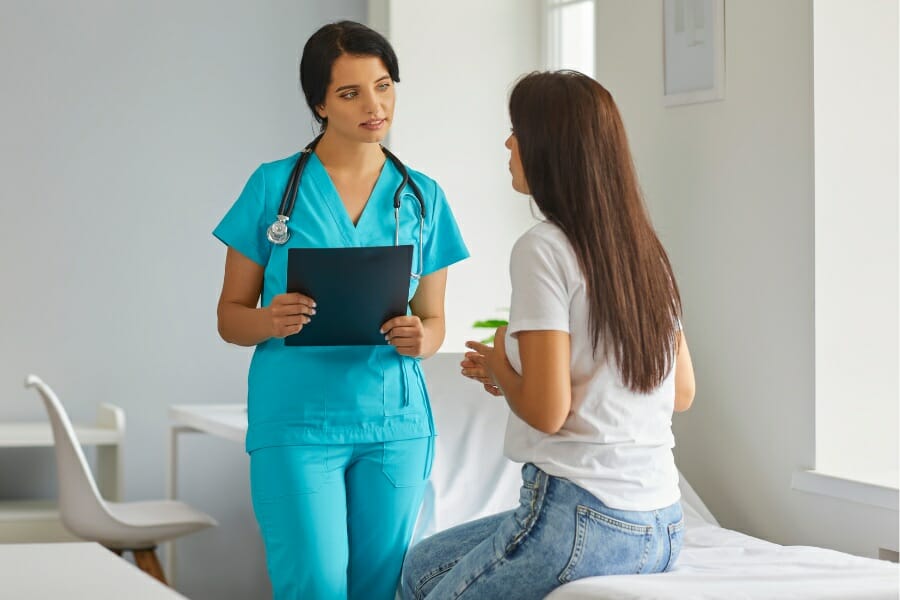 A woman discussing her health plan with an LVN