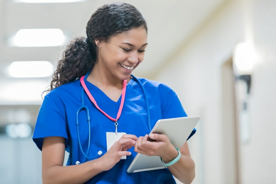 A nurse checking her assessment after medication management.