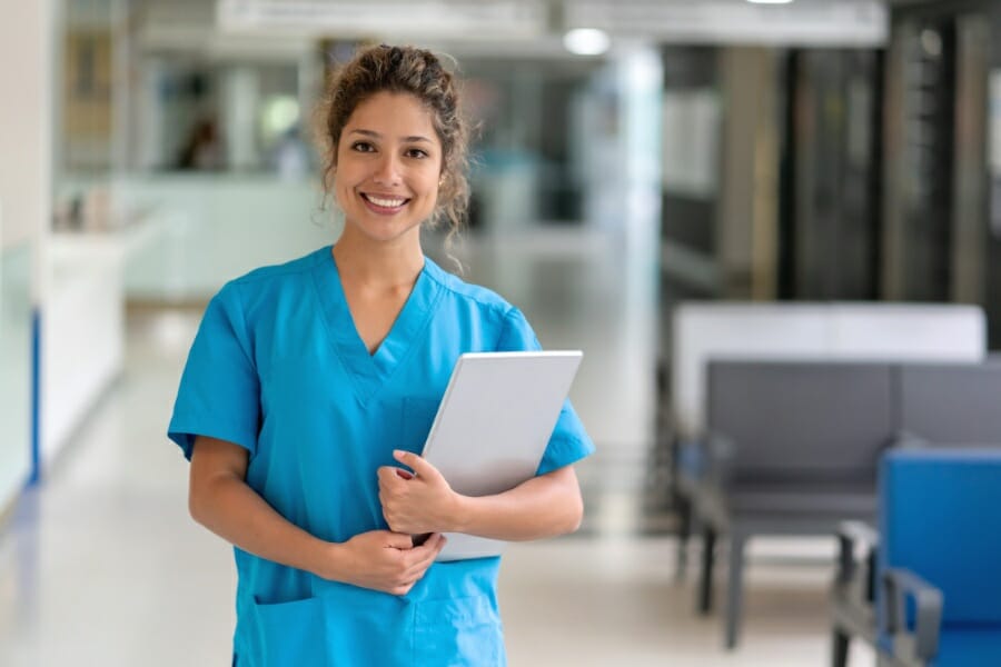 A smiling nurse with a clipboard