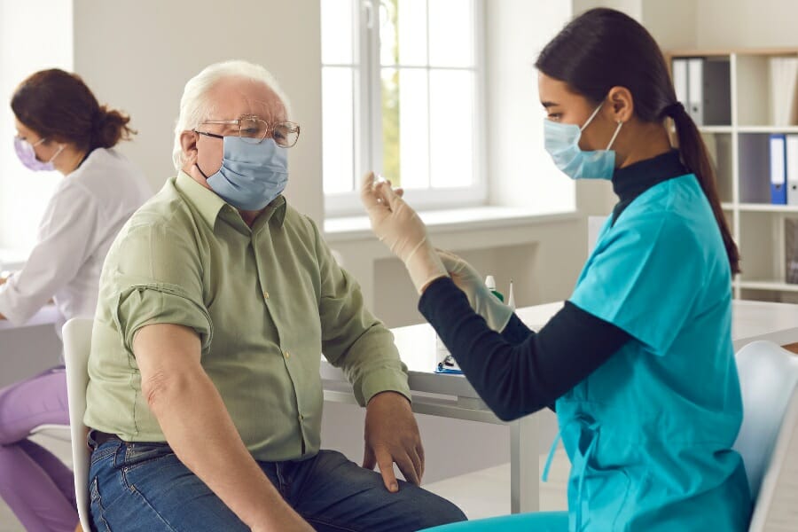 Registered nurse preparing a patient for an injection.