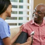 Private duty nurse smiling with an elderly patient