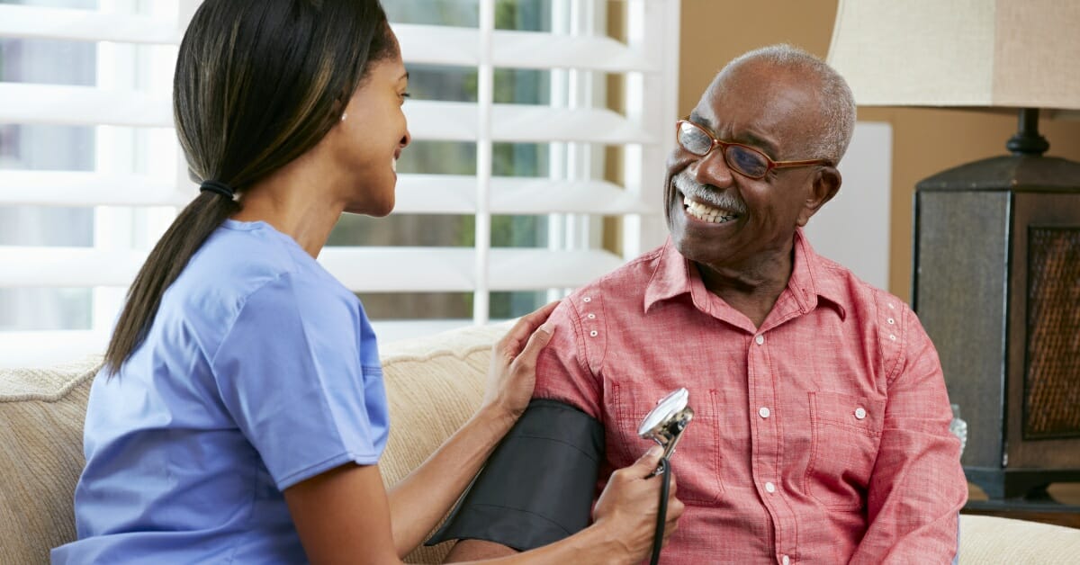 Private duty nurse smiling with an elderly patient