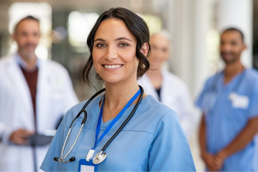 A nurse smiling at a hospital in Oakland