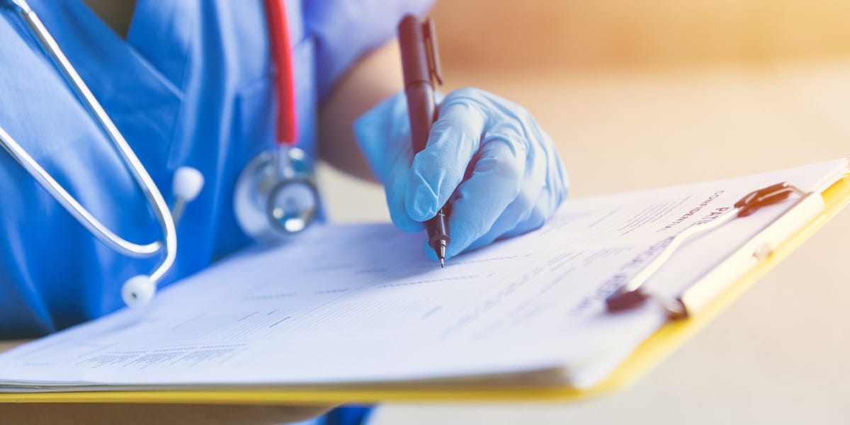 Nurse at a doctor's office updating a patient's file