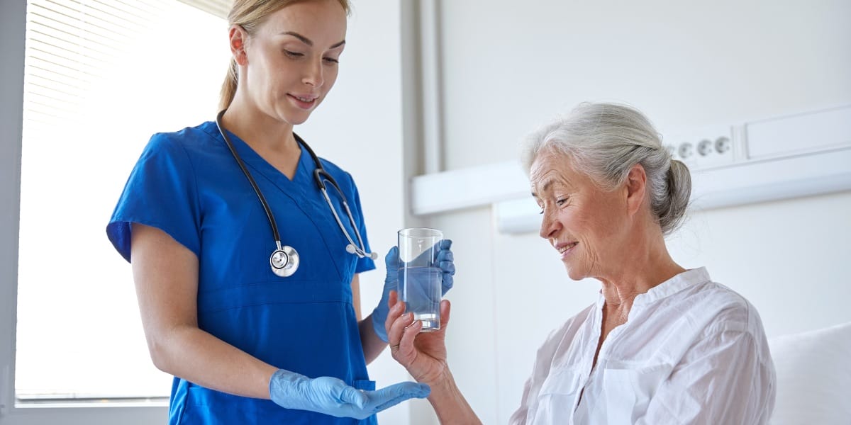 Rehab nurse providing medication for a client