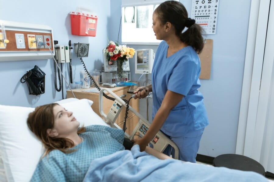 A nurse checking a patient's blood pressure in a hospital