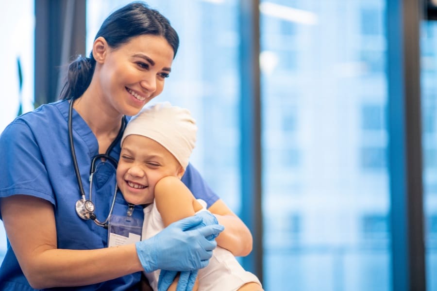 LVN embracing with a young patient