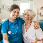 private duty nurse receiving a hug from her elderly client