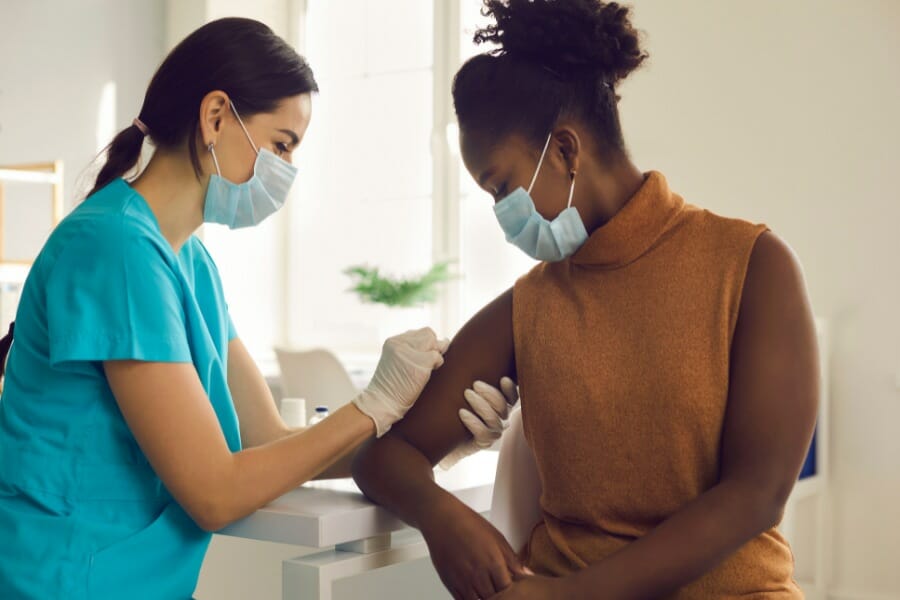 A nurse preparing for an injection in a psychiatric patient