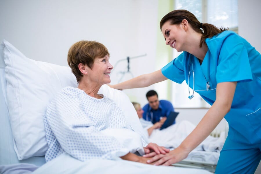 A nurse reassuring a patient at a skilled nursing facility