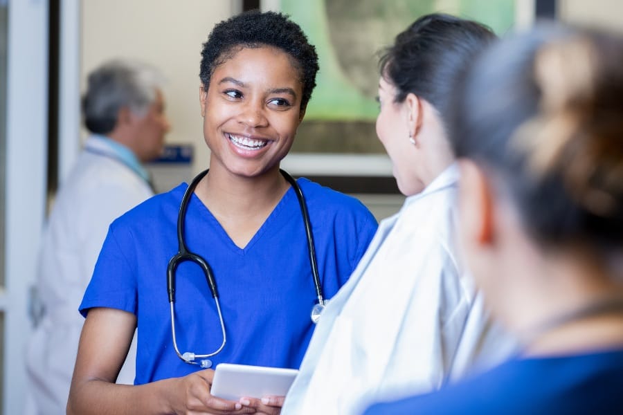 Nurses discuss a patient's record