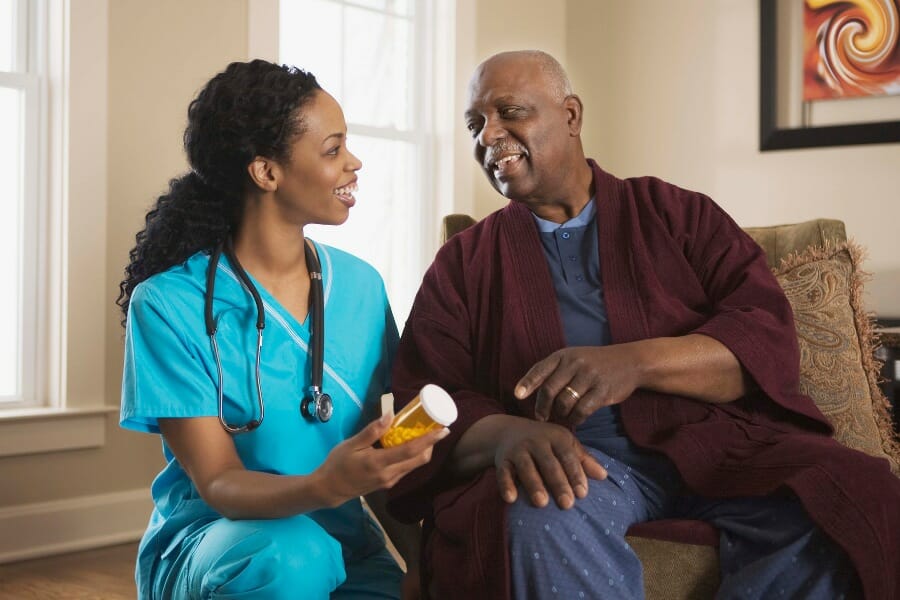 A registered nurse in Boca Raton helping a patient with medication management