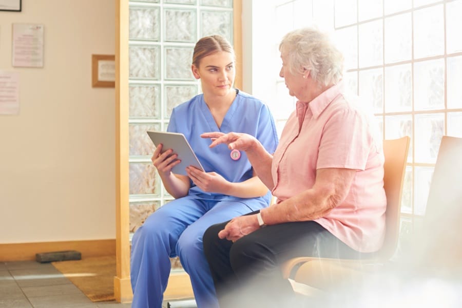 Elderly patient and a nurse in a doctor's office