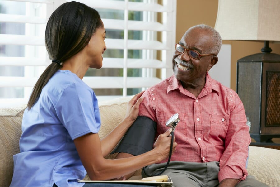 in home nurse in Miami laughing with her patient