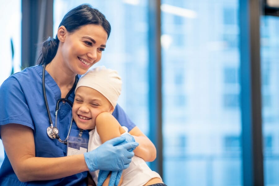 A young patient and an outsourced nurse smiling