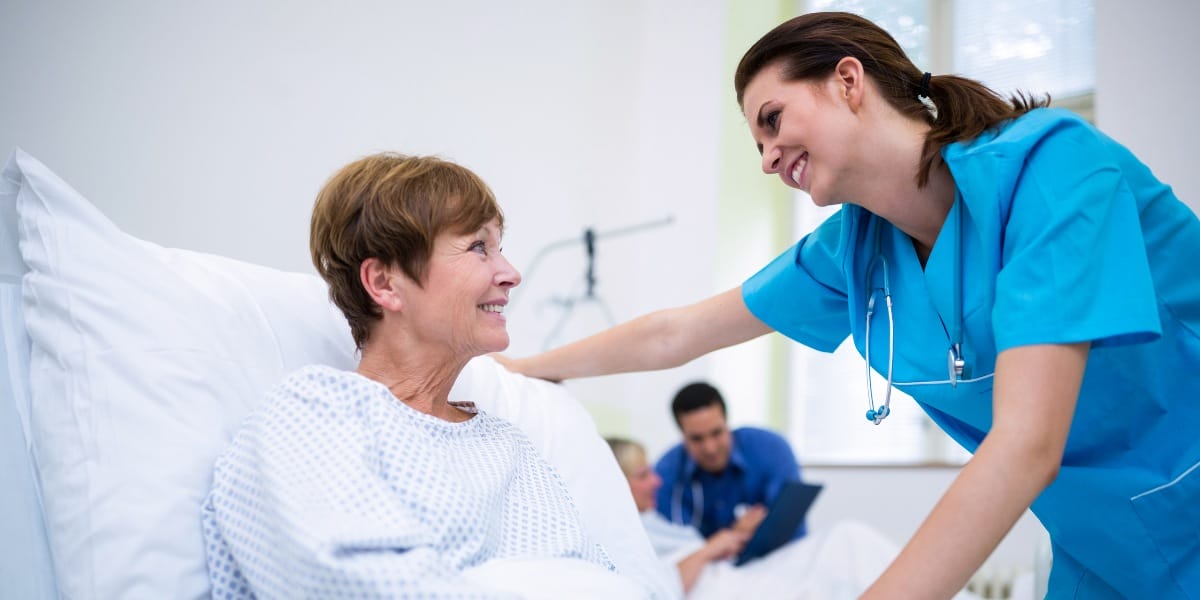 RN reassuring an elderly patient