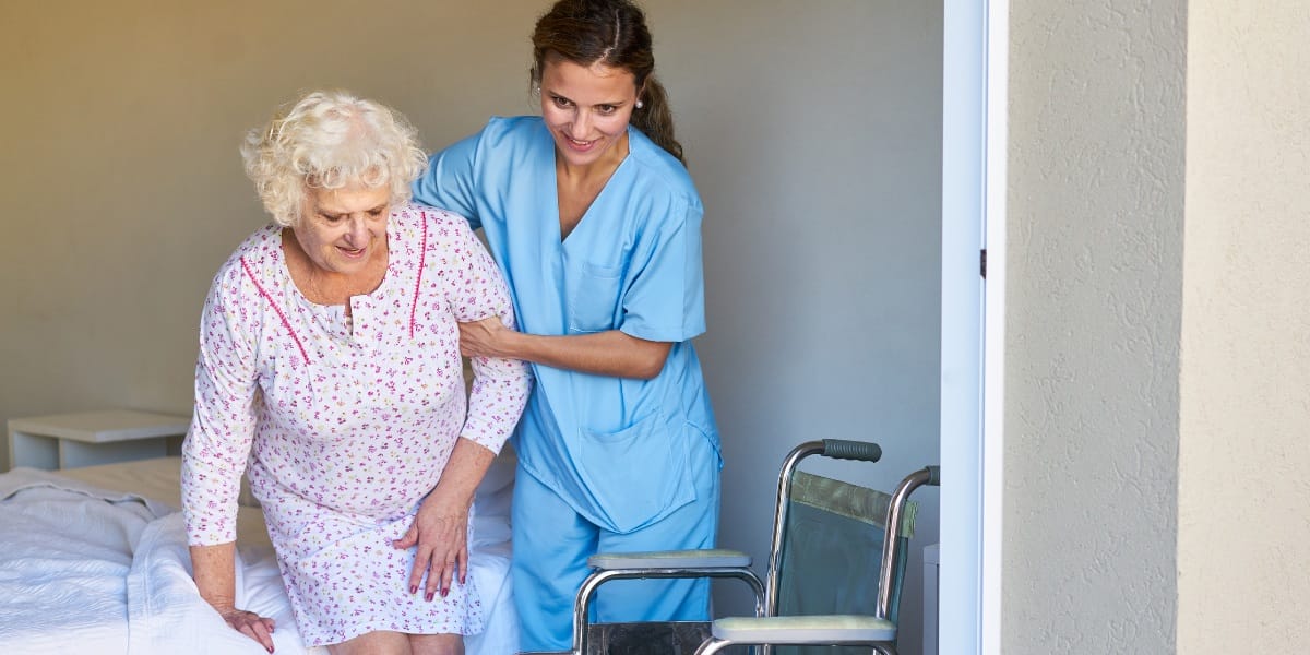 nurse assisting elderly patient