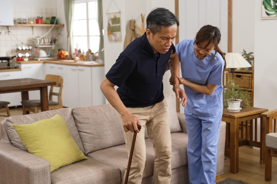 nurse assisting a patient walking