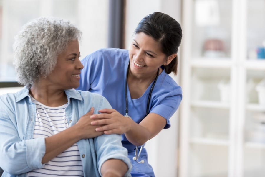 An RN comforting a patient