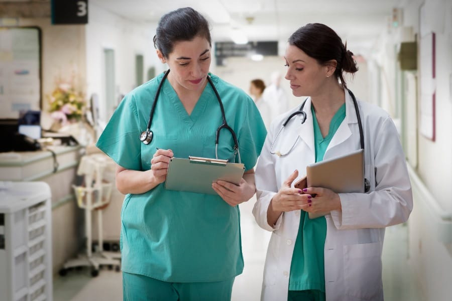nurse staff agency per diem nurses discussing a patient's record
