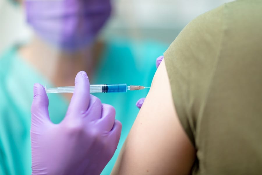 Professional nurse giving a patient an injection at the hospital