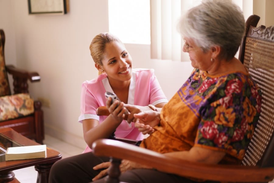 Private duty nurse assisting elderly client