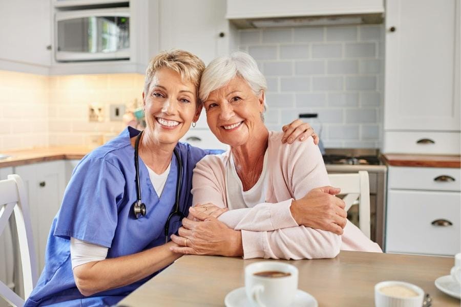 at home nurse in California smiling with her patient